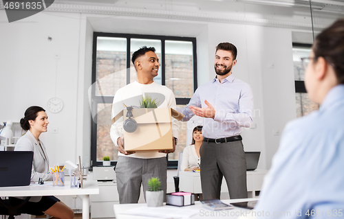 Image of new male employee meeting colleagues at office