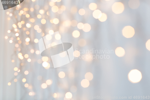 Image of christmas garland lights over grey background