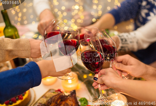 Image of close up of friends with wine celebrate christmas