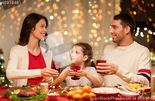 Image of happy family having christmas dinner at home