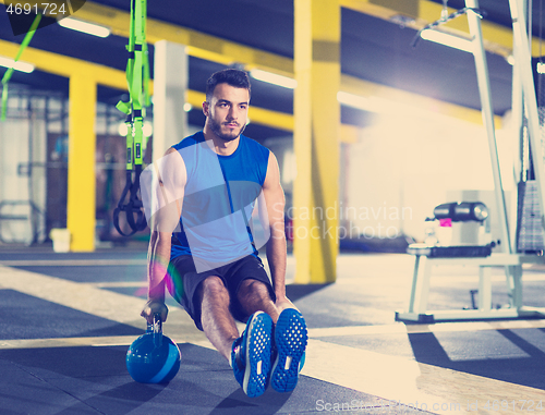 Image of Young strong man doing pushups