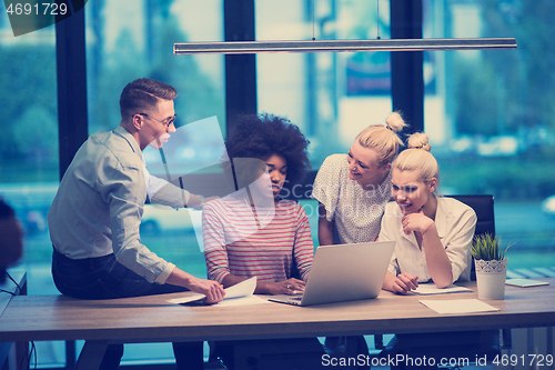 Image of Multiethnic startup business team in night office