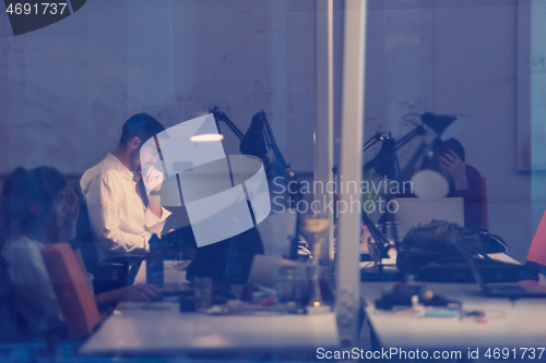 Image of businessman working using a laptop in startup office