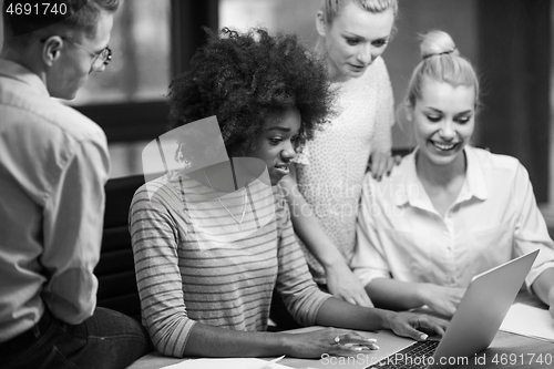 Image of Multiethnic startup business team in night office