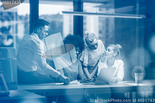 Image of Multiethnic startup business team in night office