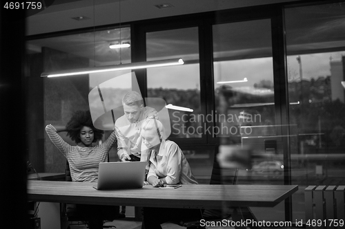 Image of Multiethnic startup business team in night office