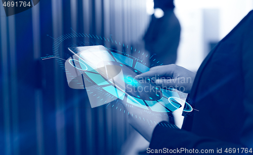 Image of Female engineer working on a tablet computer in server room