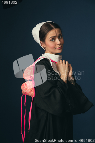 Image of Medieval young woman as a nun with bra