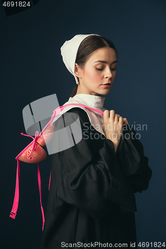 Image of Medieval young woman as a nun with bra