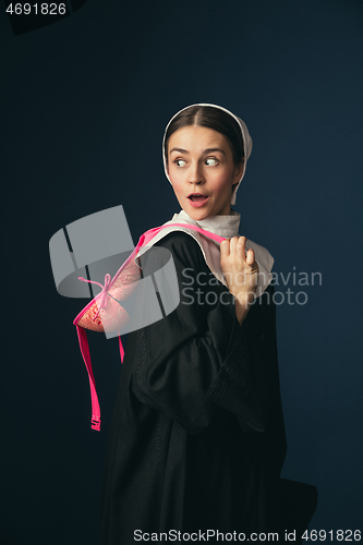 Image of Medieval young woman as a nun with bra