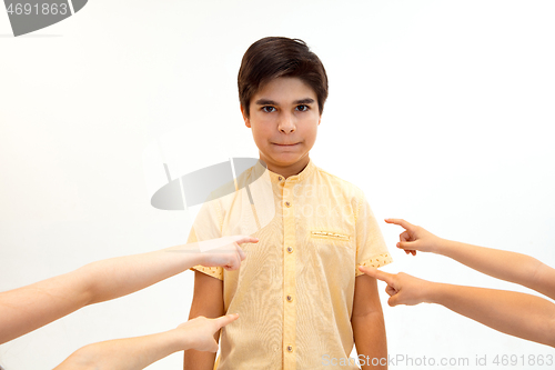 Image of Little boy standing alone and suffering an act of bullying.