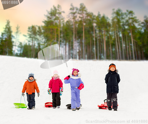 Image of happy little kids with sleds in winter