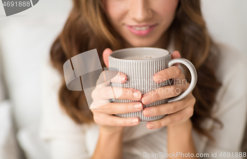 Image of close up of happy woman with cup of coffee at home