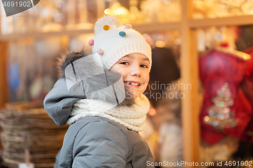 Image of happy little girl at christmas market in winter