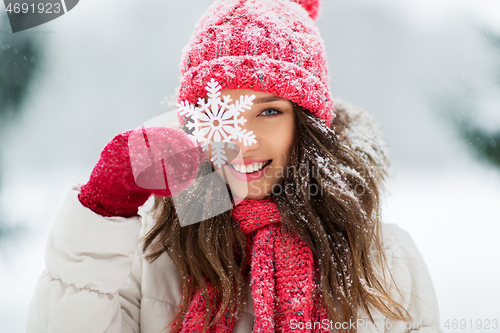 Image of portrait of teenage girl with snowflake in winter