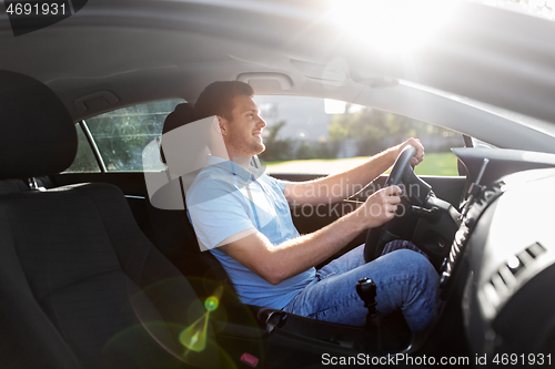 Image of smiling man or driver driving car