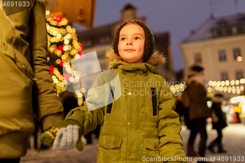 Image of happy little boy with mother at christmas market