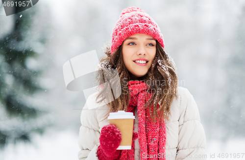 Image of happy teenage girl with coffee in winter park