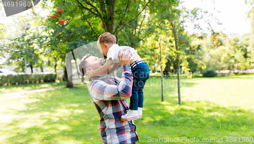 Image of happy father with son playing in summer park