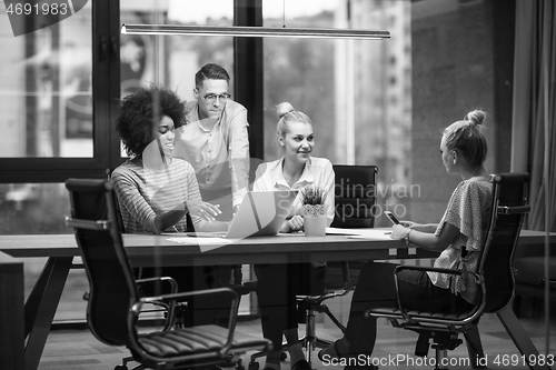 Image of Multiethnic startup business team in night office