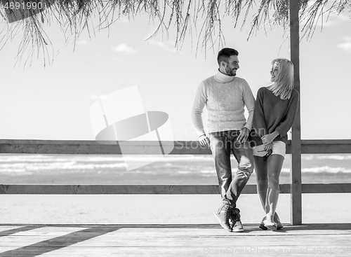 Image of Couple chating and having fun at beach bar