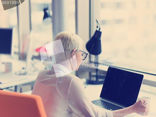 Image of businesswoman using a laptop in startup office