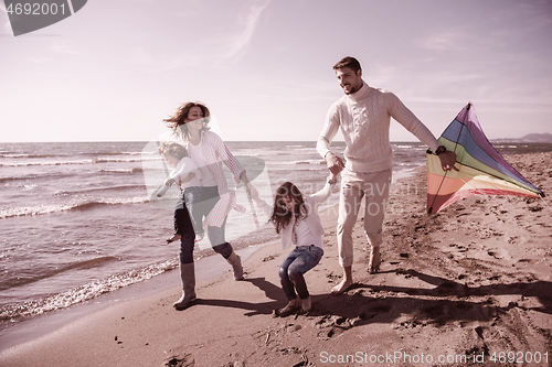 Image of happy family enjoying vecation during autumn day