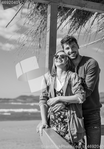 Image of Couple chating and having fun at beach bar