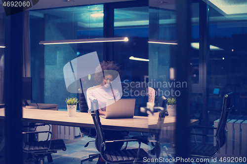 Image of black businesswoman using a laptop in startup office