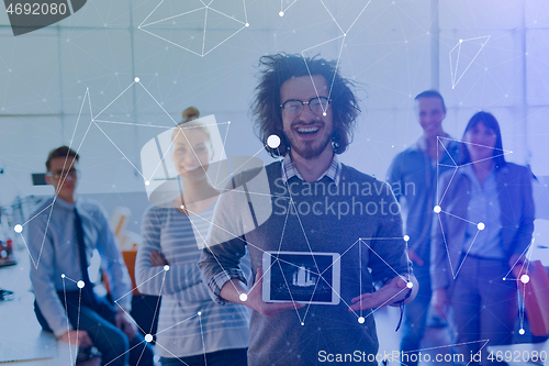 Image of Portrait of a young businessman holding tablet
