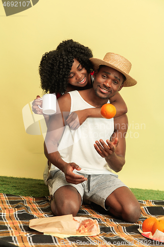 Image of Happy family having picnic at studio