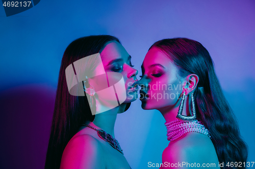 Image of High Fashion models in colorful bright neon lights posing at studio