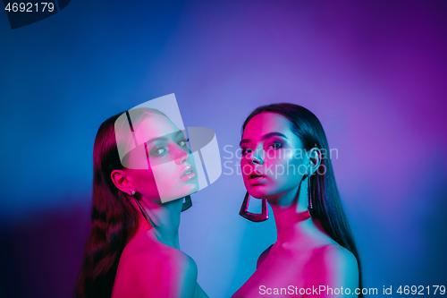 Image of High Fashion models in colorful bright neon lights posing at studio