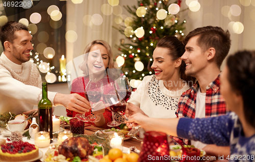 Image of friends celebrating christmas and drinking wine