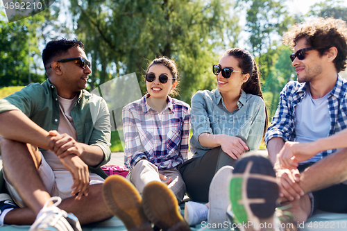 Image of friends hanging out and talking outdoors in summer