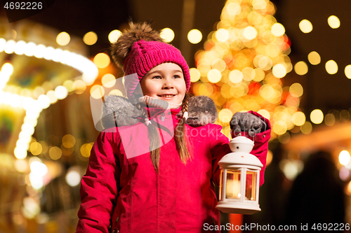 Image of happy little girl at christmas with lantern market