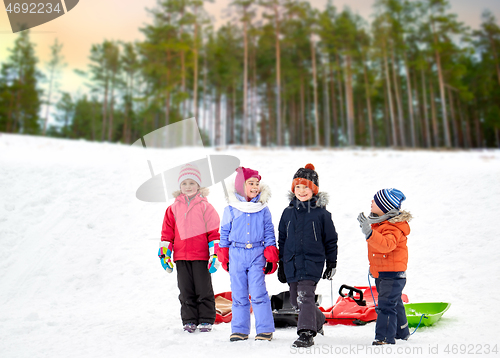 Image of happy little kids with sleds in winter