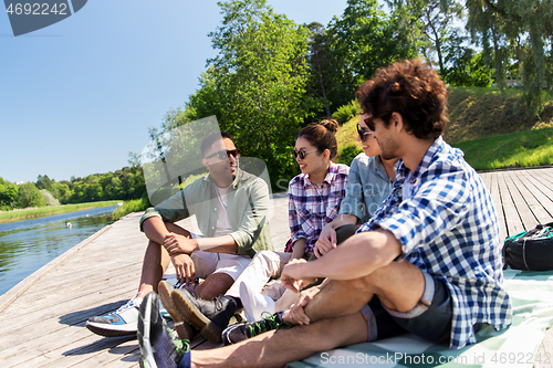 Image of friends hanging out and talking outdoors in summer