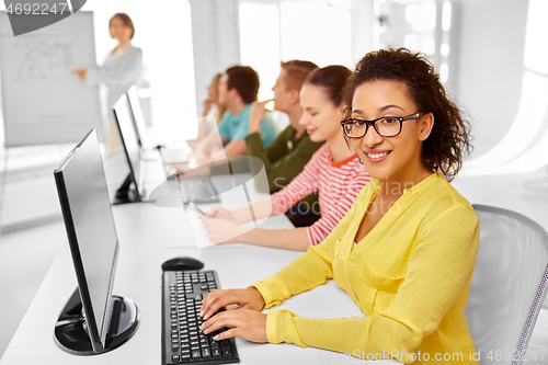 Image of happy high school students in computer class