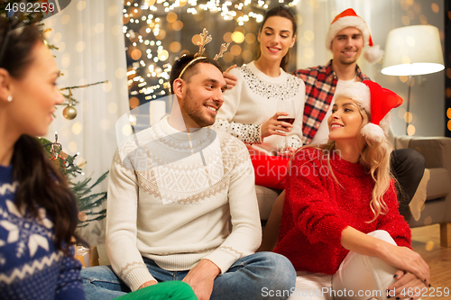 Image of friends celebrating christmas and drinking wine