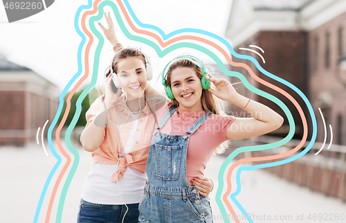 Image of teenage girls or friends in headphones in city