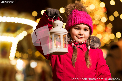 Image of happy little girl at christmas with lantern market