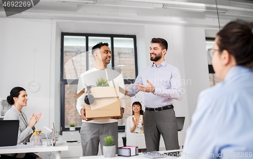 Image of new male employee meeting colleagues at office