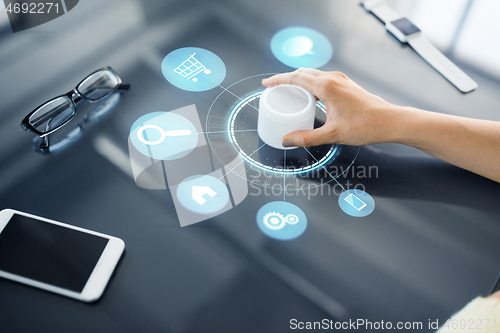 Image of hand with app icons on interactive panel