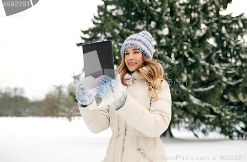 Image of woman with tablet computer outdoors in winter