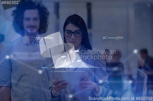 Image of young Business People Working With Tablet in startup office