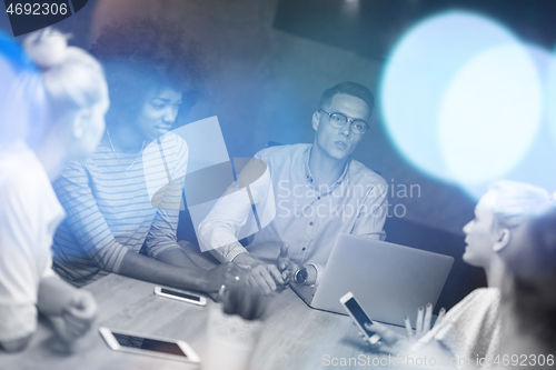 Image of Multiethnic startup business team in night office