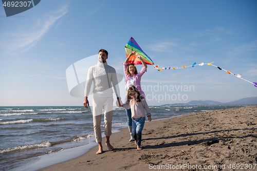 Image of happy family enjoying vecation during autumn day