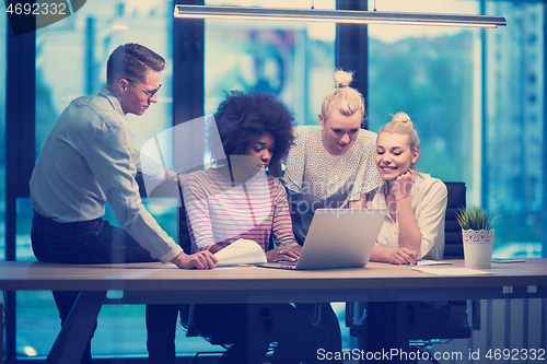 Image of Multiethnic startup business team in night office