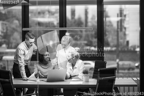 Image of Multiethnic startup business team in night office